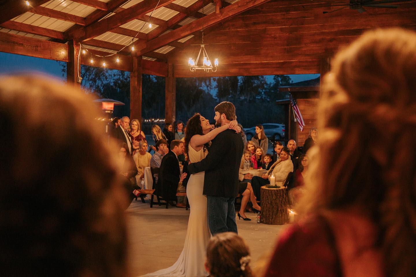 Guests dancing under warm evening pavilion lights.