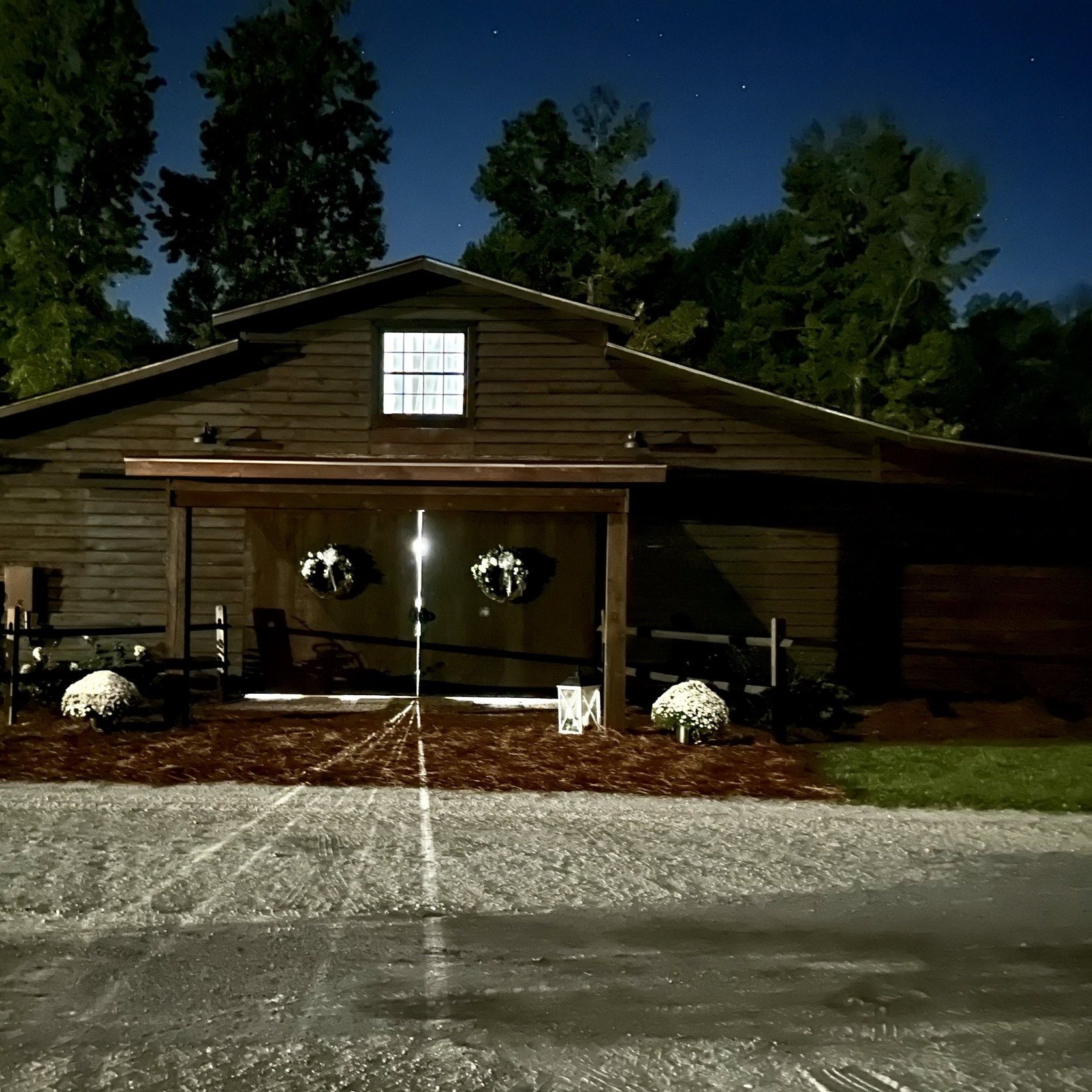 The Horse Barn glowing warmly at night.